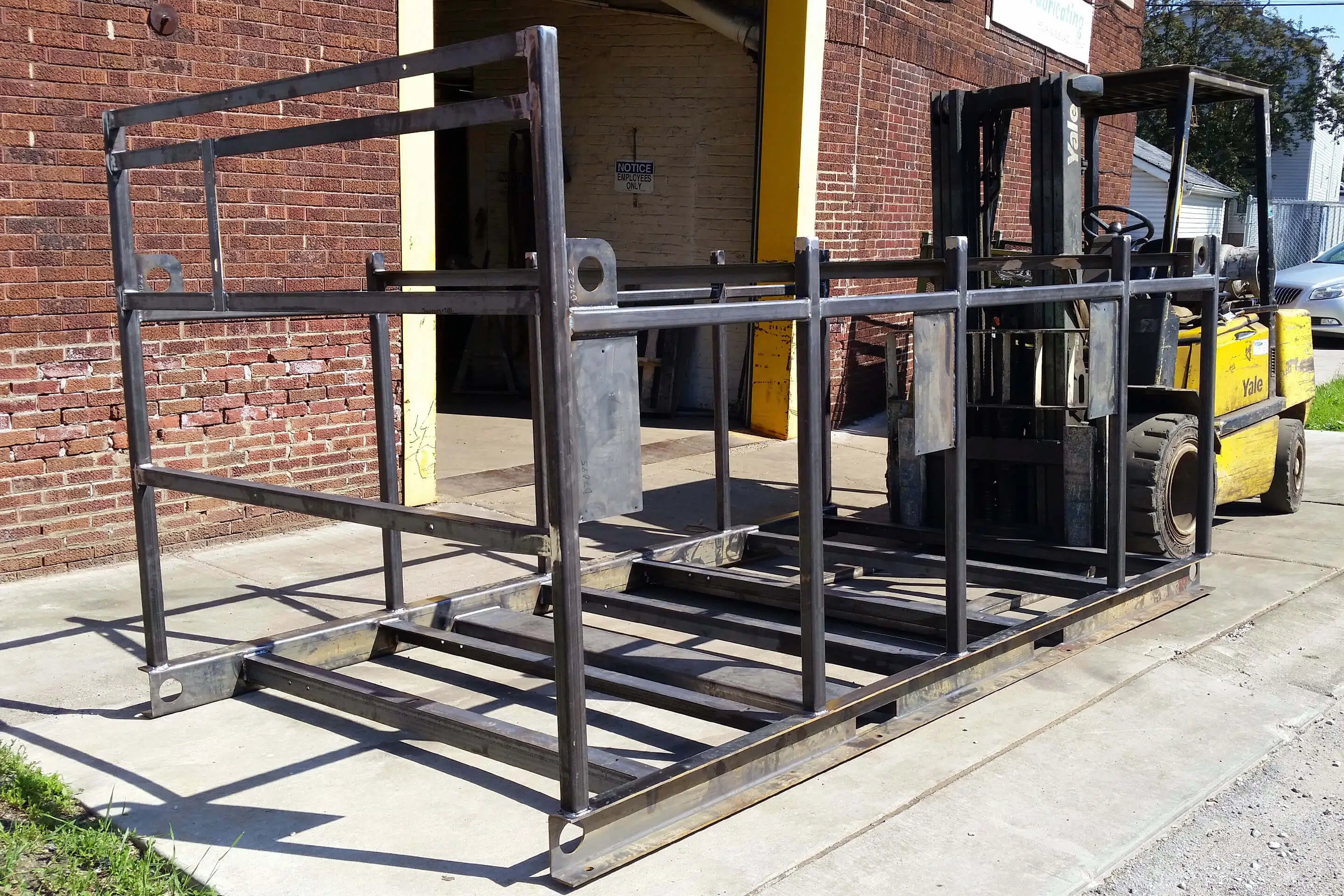 Forklift moving recently fabricated metal frame